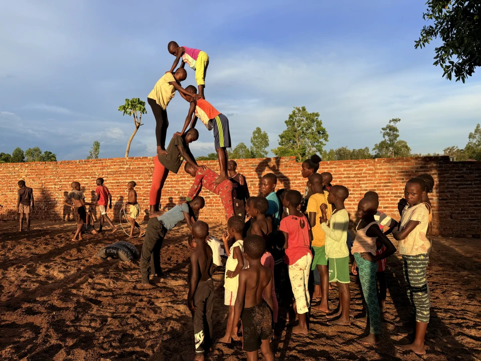 Clon Circus Uganda acrobats practising a human pyramid together